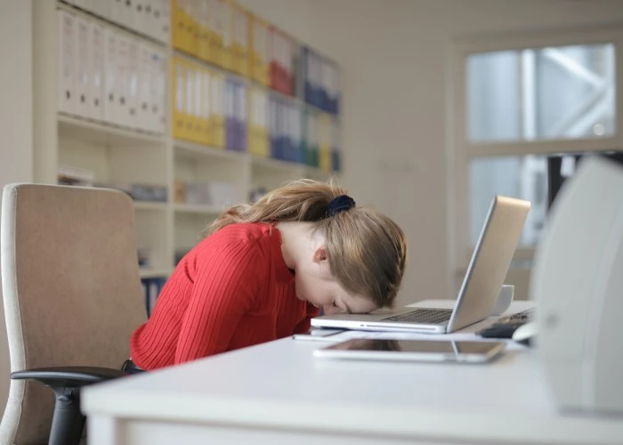 Lady asleep at her desk in an office